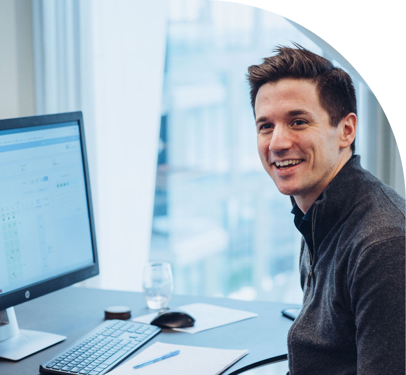 Image of man with computer smiling